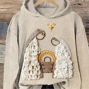Beige Hoodie with Embroidered Design representing Christ birth.